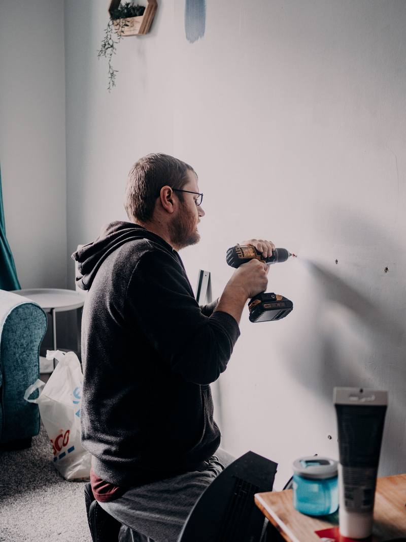 Tradesman drilling into a wall